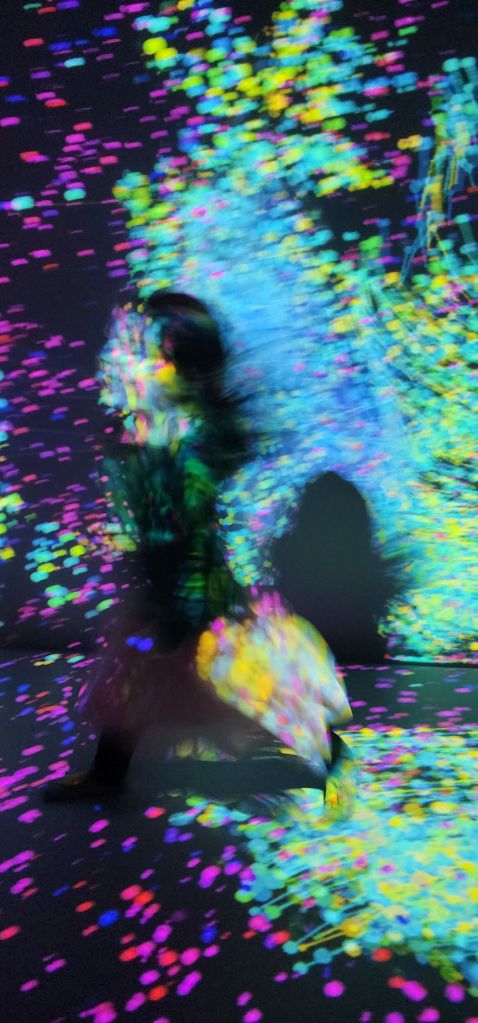 a child dancing blurred and lit up by colorful lights