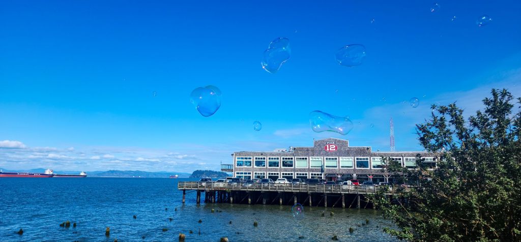 Huge soap bubbles over the edge of the Columbia river