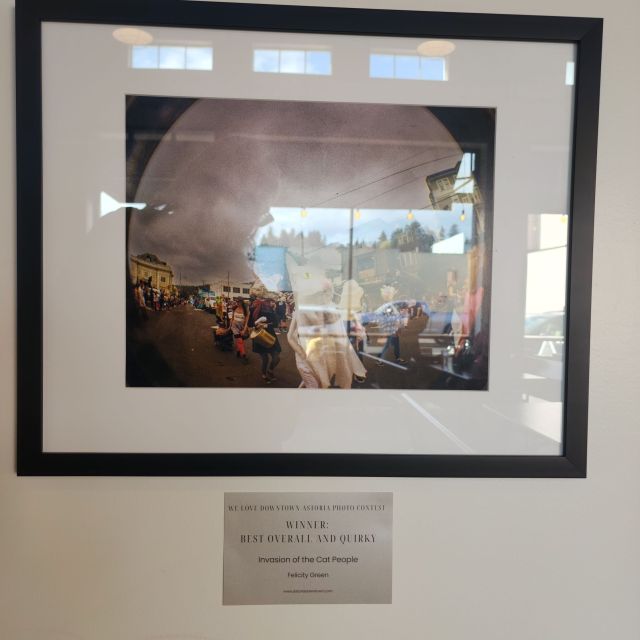a reflective photo of a framed photo with a plaque under it
