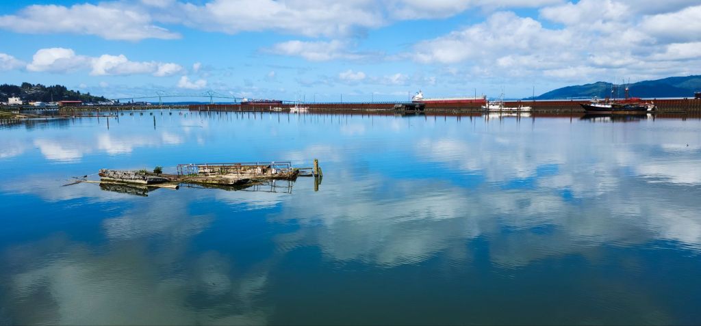 blue sky and clouds reflected in harbor water